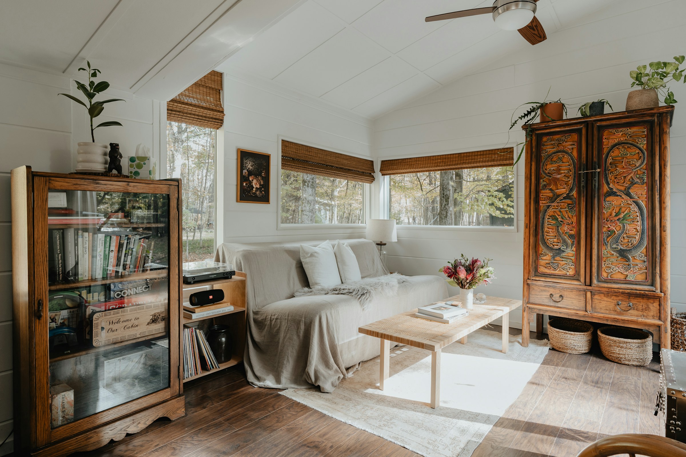 Sunlit living room with restored wooden furniture and lived-in decor
